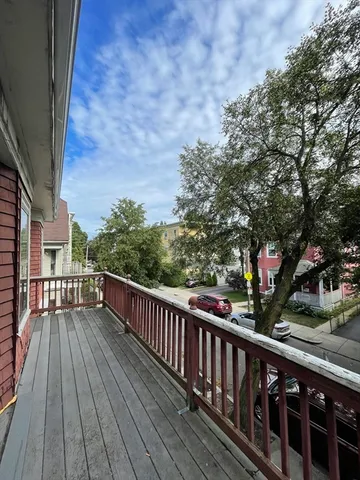 a view of a balcony with wooden floor