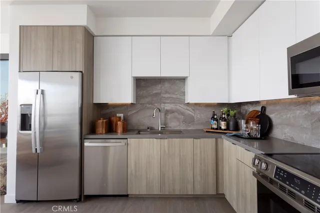 a kitchen with cabinets and stainless steel appliances