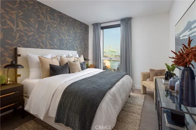 a bedroom with bed and a potted plant