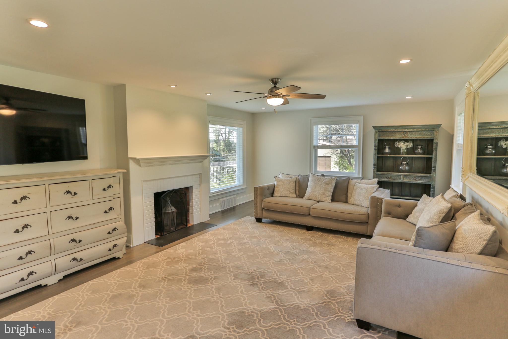 700 Panorama Road Villanova, PA 19085 - Photo 11 of 34 a living room with furniture a fireplace and a flat screen tv