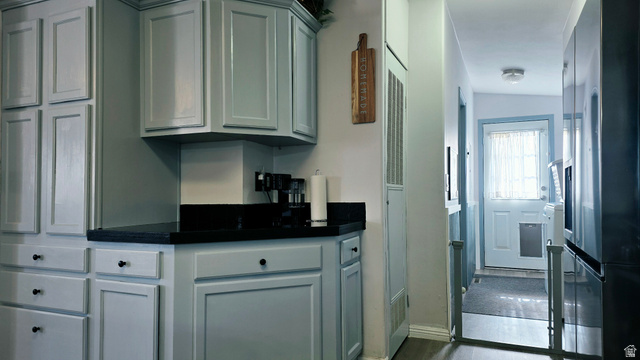 401 West 2000th Street South Vernal, UT 84078 - Photo 8 of 26 Kitchen area featuring light blue cabinetry with dark pulls, dark countertops, and a full-height built-in cabinet
