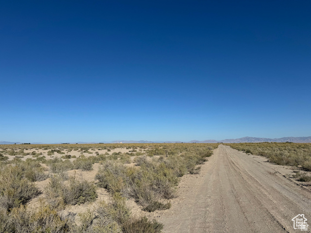 6000 North 10000th West Delta, UT 84624 - Photo 9 of 20 View of dirt / gravel road featuring a view of countryside, a mountain view, and view of desert landscape