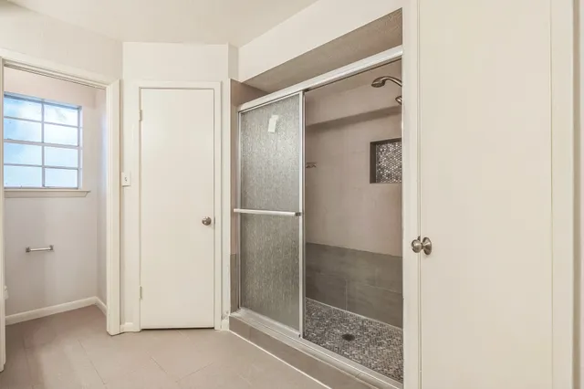 a bathroom with a glass shower door