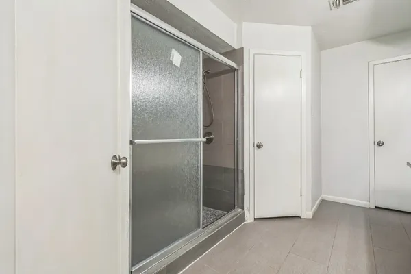 a bathroom with a glass shower door