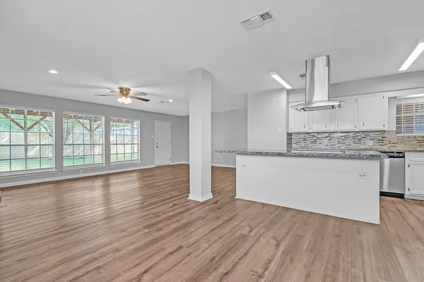 a view of large kitchen with wooden floor and outdoor space