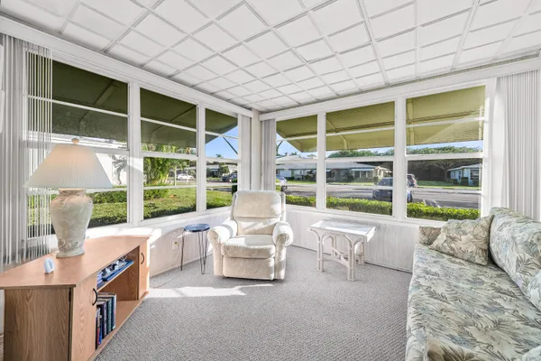 a living room with furniture windows and a table