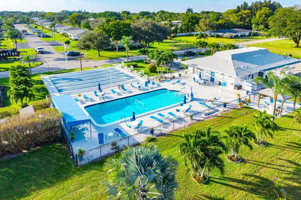 a view of a swimming pool with a yard and sitting area