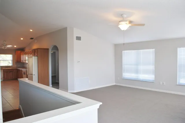 a view of kitchen and hall with a window