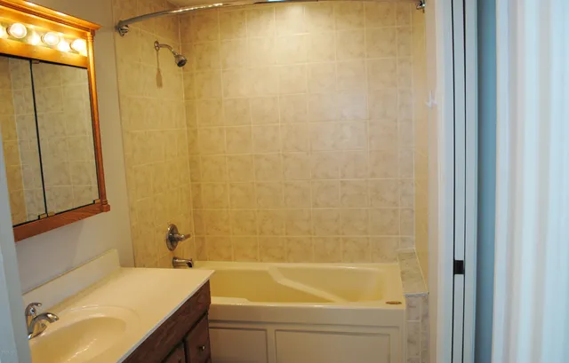 a bathroom with a tub and sink