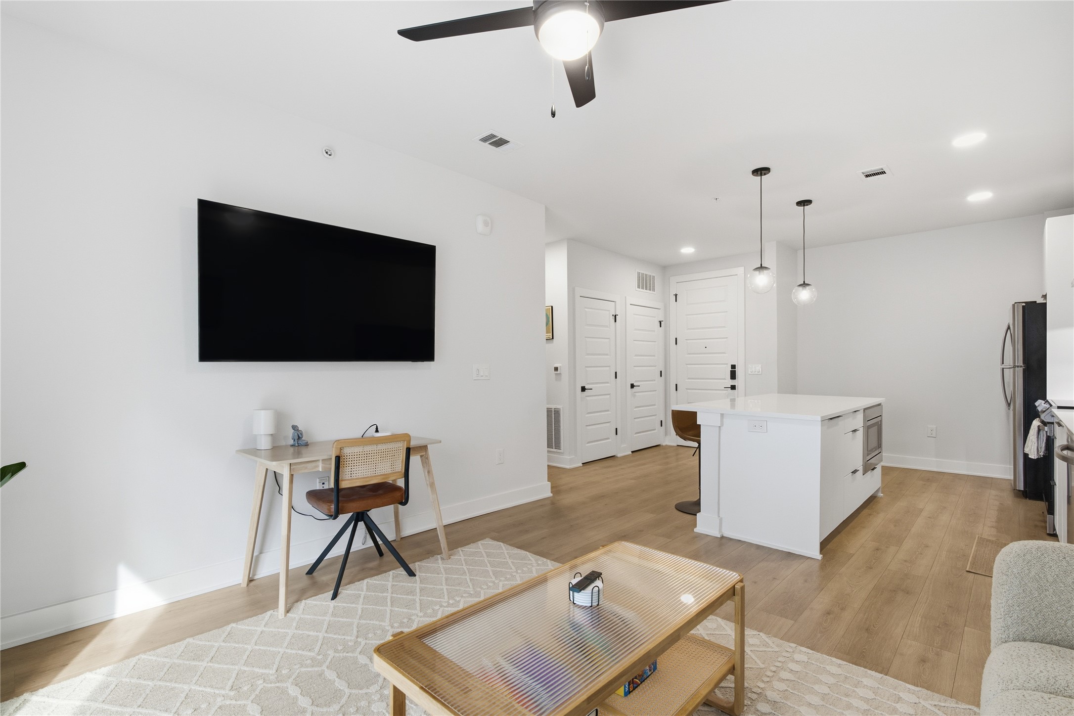 2500 Longview Street, Unit 219 Austin, TX 78705 - Photo 9 of 40 Living room with light wood-style flooring, a ceiling fan, and recessed lighting