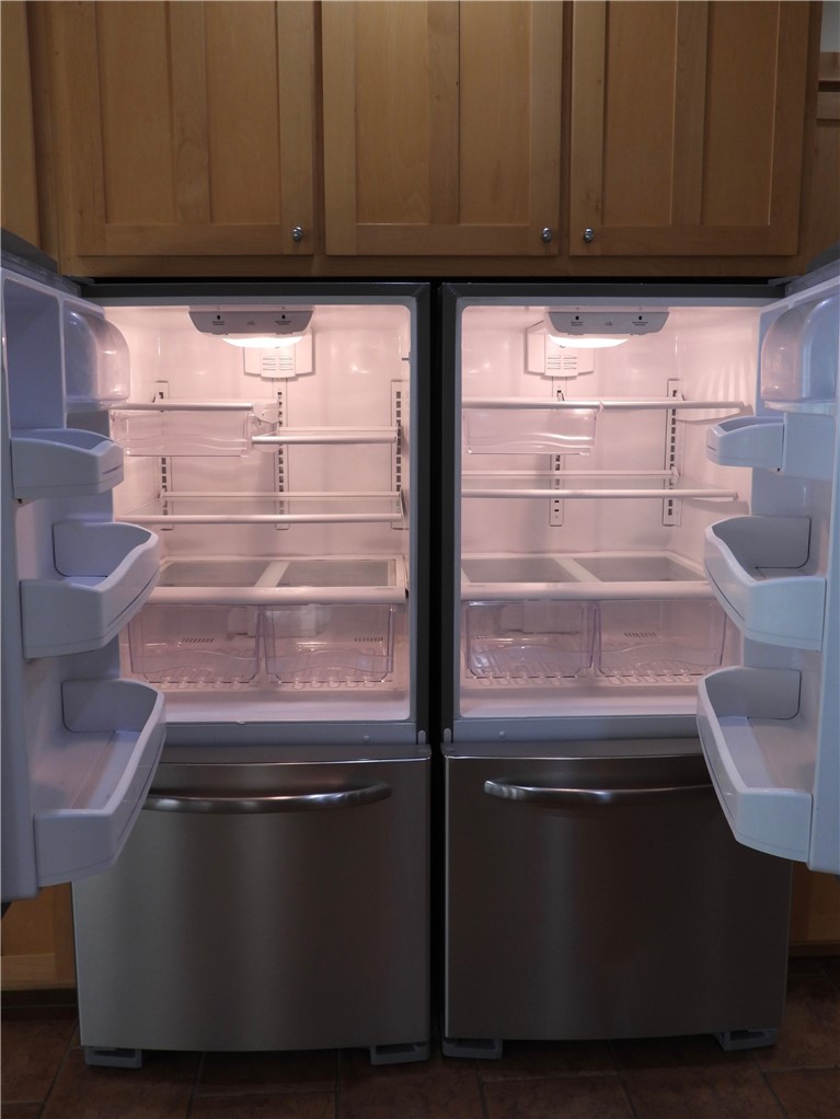 19489 Oak Circle Springdale, AR 72764 - Photo 6 of 58 Dual stainless steel refrigerators with internal lighting and ample storage, integrated beneath wood-finish cabinetry