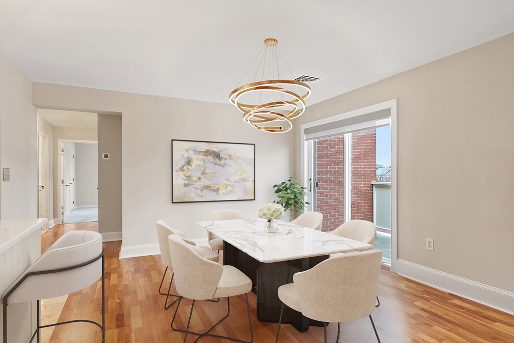 20 Central Street, Unit 402 Salem, MA 01970 - Photo 11 of 36 a view of a dining room with furniture and wooden floor