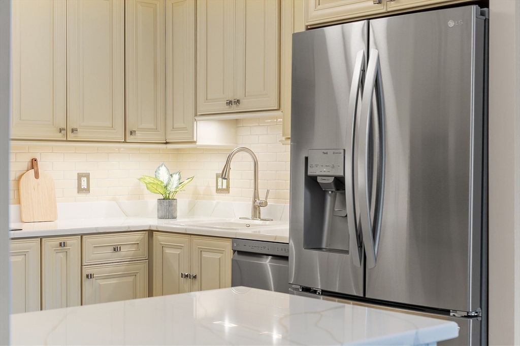 20 Central Street, Unit 402 Salem, MA 01970 - Photo 13 of 36 a kitchen with stainless steel appliances granite countertop a refrigerator sink and cabinets