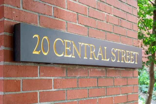 a street sign on a brick wall