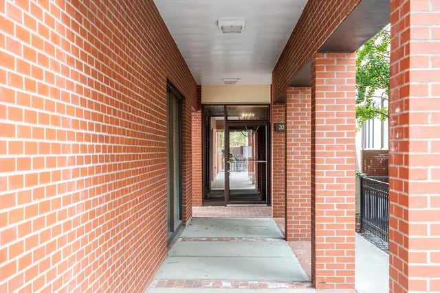 a view of a brick house with a door and wooden floor