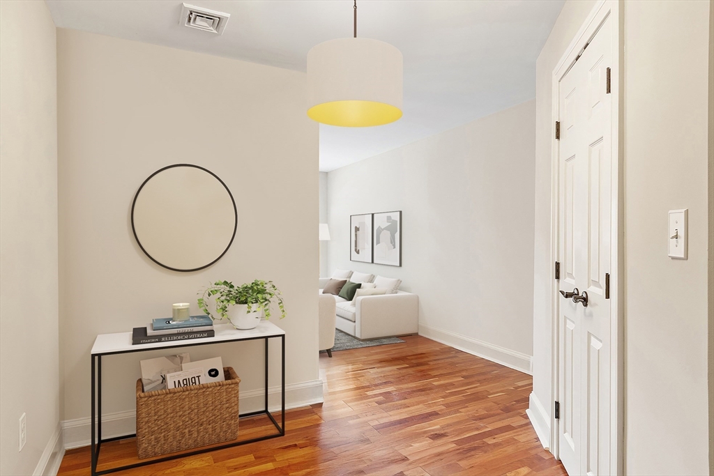 20 Central Street, Unit 402 Salem, MA 01970 - Photo 8 of 36 a view of a bedroom with wooden floor and furniture