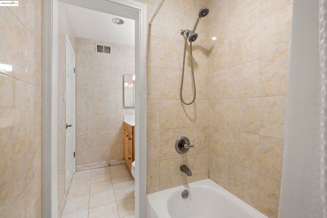 a bathroom with a bath tub with a shower
