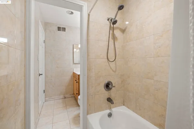a bathroom with a bath tub with a shower