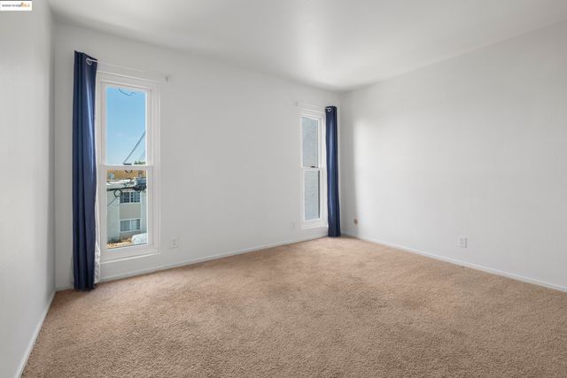 a view of an empty room and a window