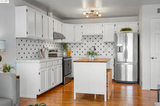 a kitchen with stainless steel appliances a refrigerator sink and cabinets