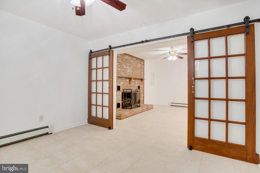 936 Grace Road Huntingtown, MD 20639 - Photo 49 of 64 an empty room with chandelier fan and windows