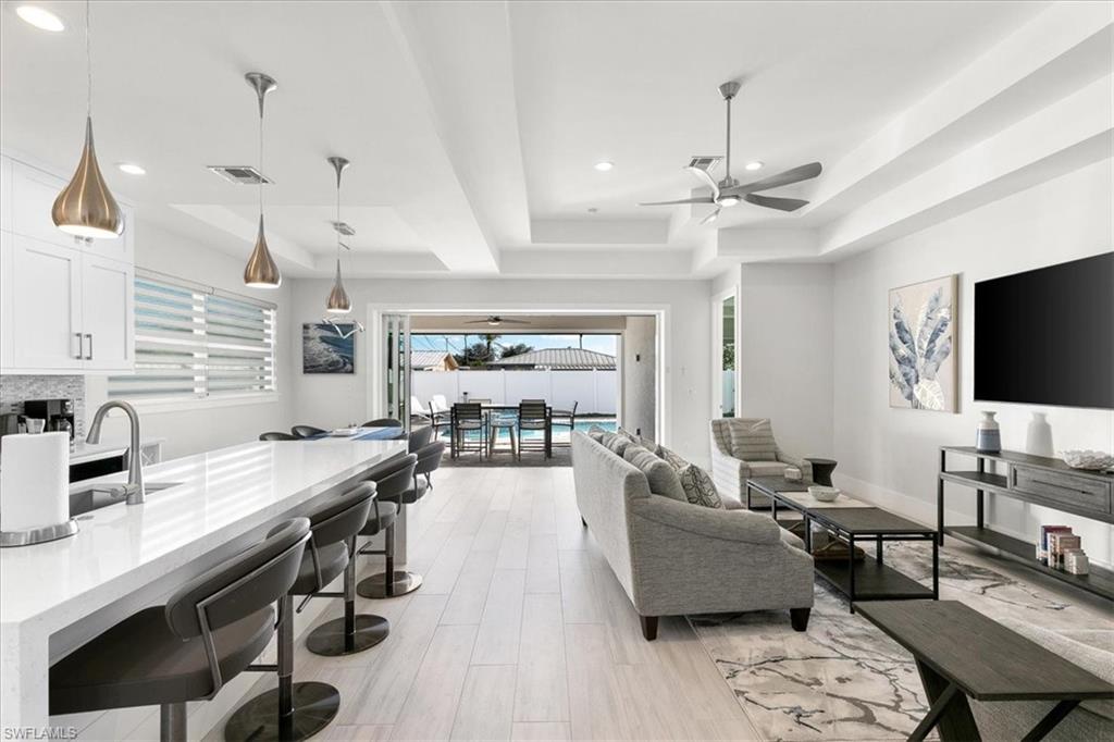 734 109th Avenue North Naples, FL 34108 - Photo 1 of 34 a living room with lots of furniture and a flat screen tv