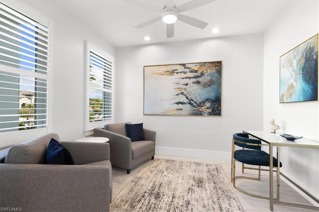 734 109th Avenue North Naples, FL 34108 - Photo 13 of 34 a living room with furniture and a large window
