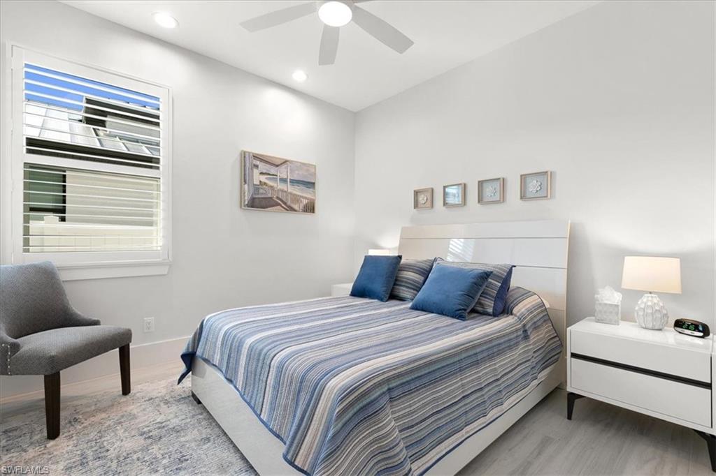 734 109th Avenue North Naples, FL 34108 - Photo 14 of 34 a bedroom with a bed and a couch