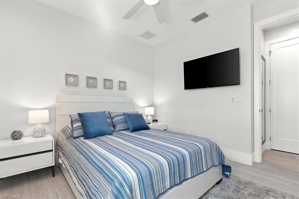 734 109th Avenue North Naples, FL 34108 - Photo 15 of 34 a bedroom with a bed and a flat screen tv