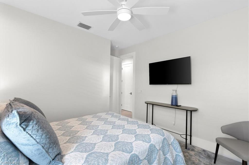 734 109th Avenue North Naples, FL 34108 - Photo 17 of 34 a bedroom with a bed and a flat screen tv