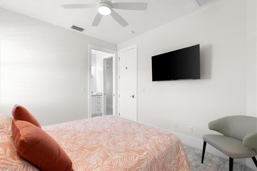 734 109th Avenue North Naples, FL 34108 - Photo 20 of 34 a bedroom with a bed and a flat screen tv