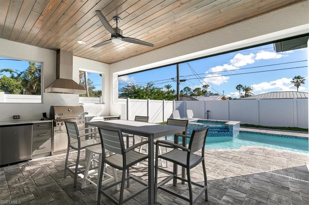 734 109th Avenue North Naples, FL 34108 - Photo 22 of 34 a kitchen with a table and chairs in it
