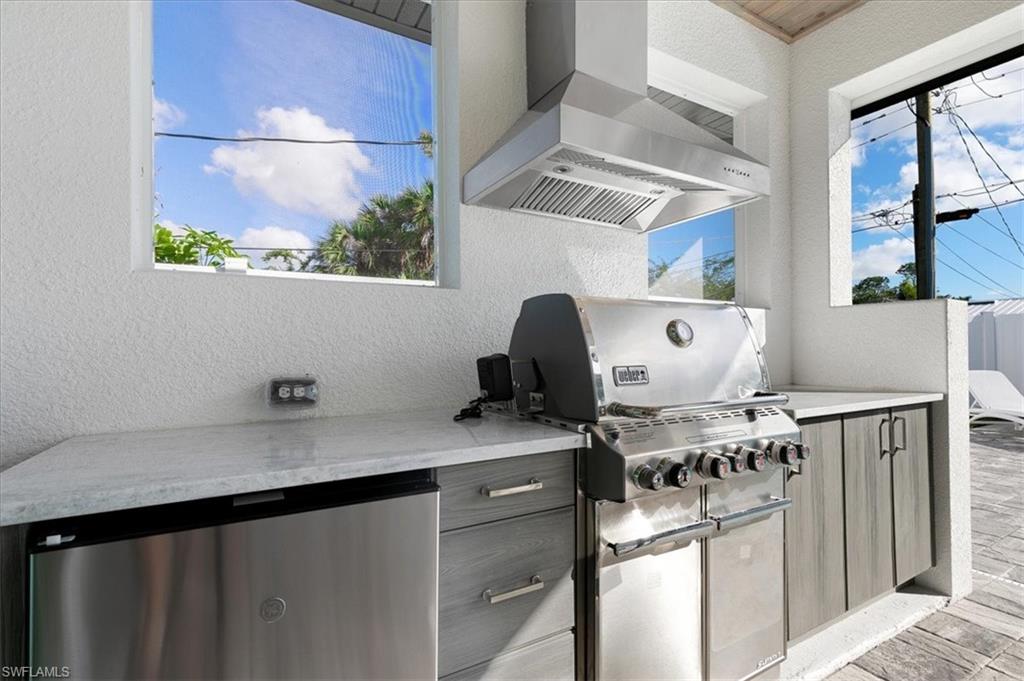 734 109th Avenue North Naples, FL 34108 - Photo 27 of 34 a kitchen with stainless steel appliances a sink a stove and a refrigerator