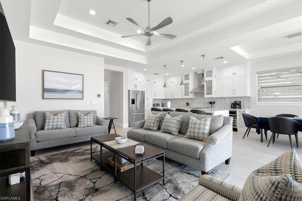 734 109th Avenue North Naples, FL 34108 - Photo 29 of 34 a living room with furniture kitchen view and a chandelier