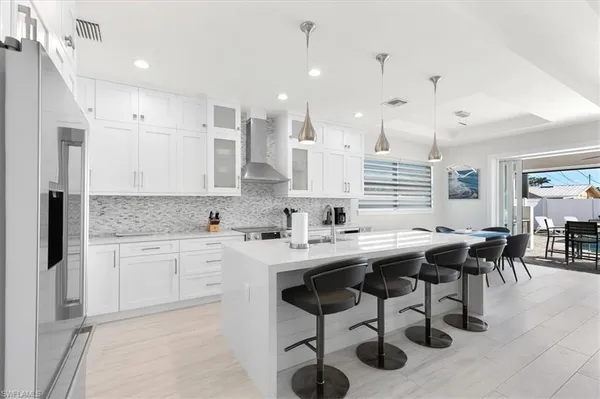 a kitchen with stainless steel appliances kitchen island granite countertop a sink and cabinets