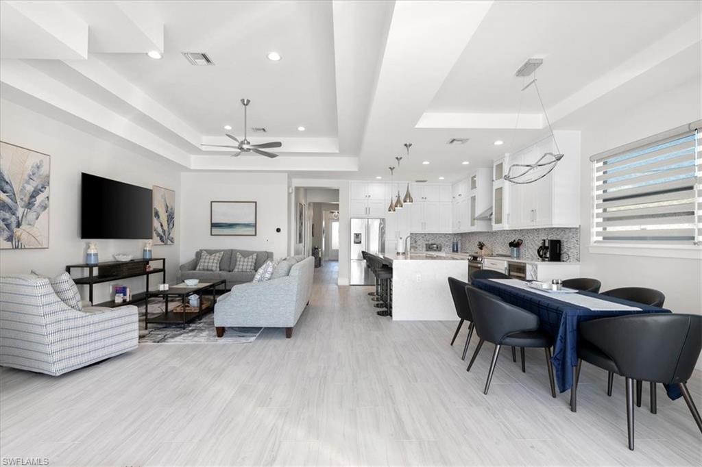 734 109th Avenue North Naples, FL 34108 - Photo 6 of 34 a living room with furniture and a flat screen tv