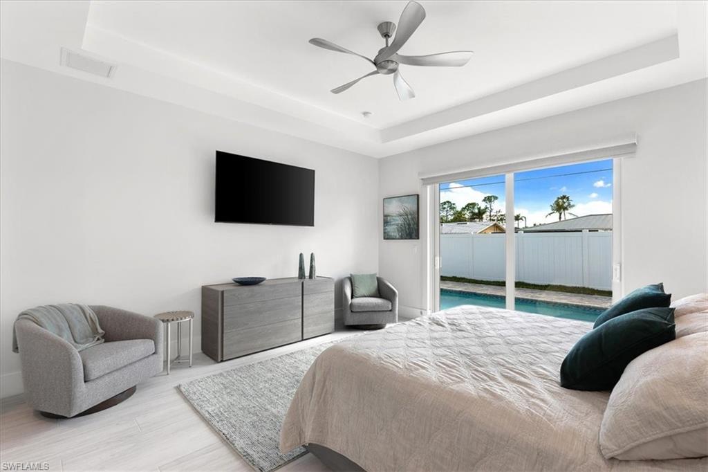 734 109th Avenue North Naples, FL 34108 - Photo 7 of 34 a bedroom with a bed and a flat screen tv