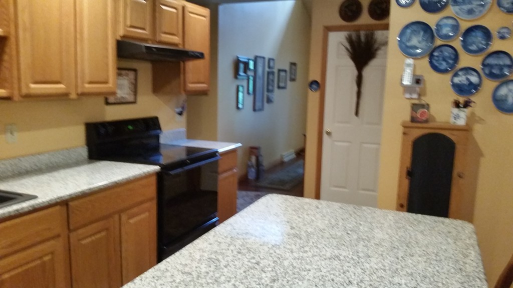 351 Quaddick Road Thompson, CT 06277 - Photo 18 of 28 a kitchen with stainless steel appliances kitchen island a stove a sink and a refrigerator
