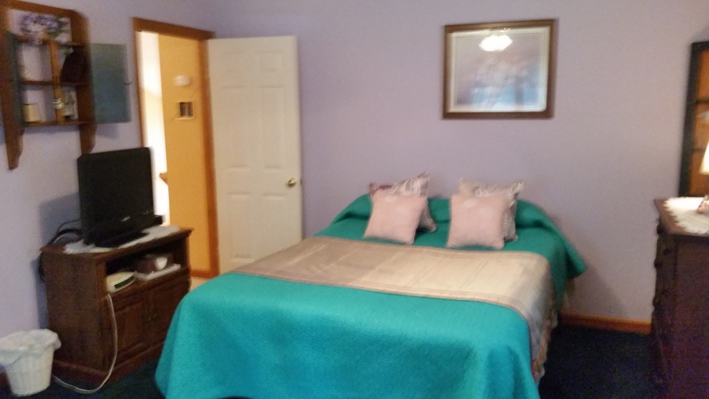 351 Quaddick Road Thompson, CT 06277 - Photo 25 of 28 a bedroom with a bed and wooden floor