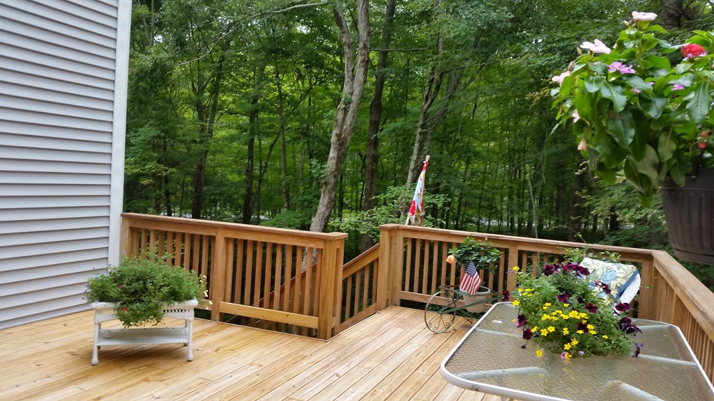 351 Quaddick Road Thompson, CT 06277 - Photo 6 of 28 a view of a chair and table on the wooden floor