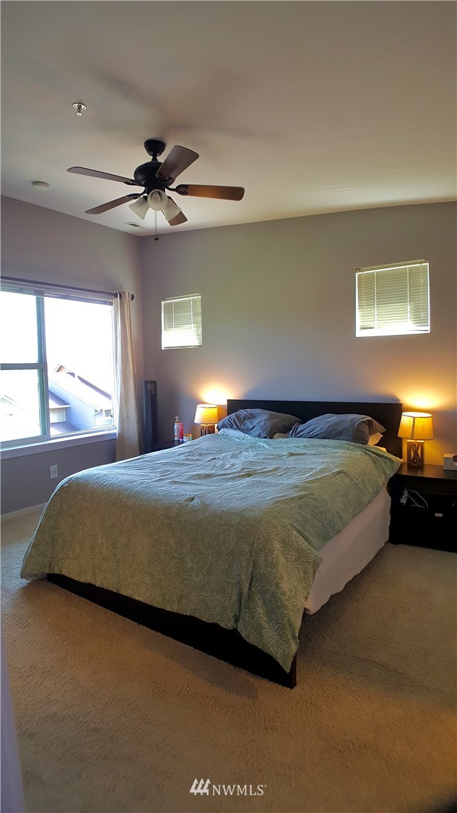 135 Cougar Ridge Road Northwest Issaquah, WA 98027 - Photo 11 of 22 a bedroom with a bed and window