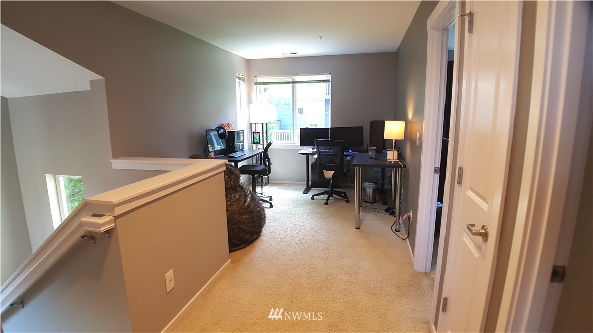 135 Cougar Ridge Road Northwest Issaquah, WA 98027 - Photo 17 of 22 a view of a workspace with furniture and a window