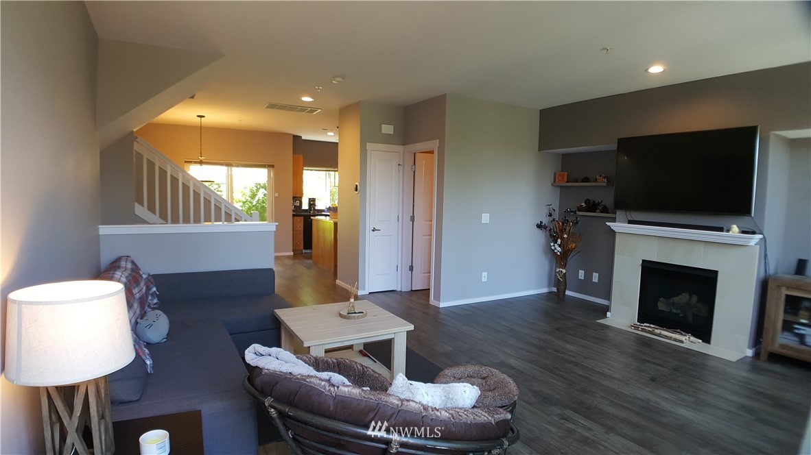 135 Cougar Ridge Road Northwest Issaquah, WA 98027 - Photo 6 of 22 a living room with furniture a fireplace and a flat screen tv