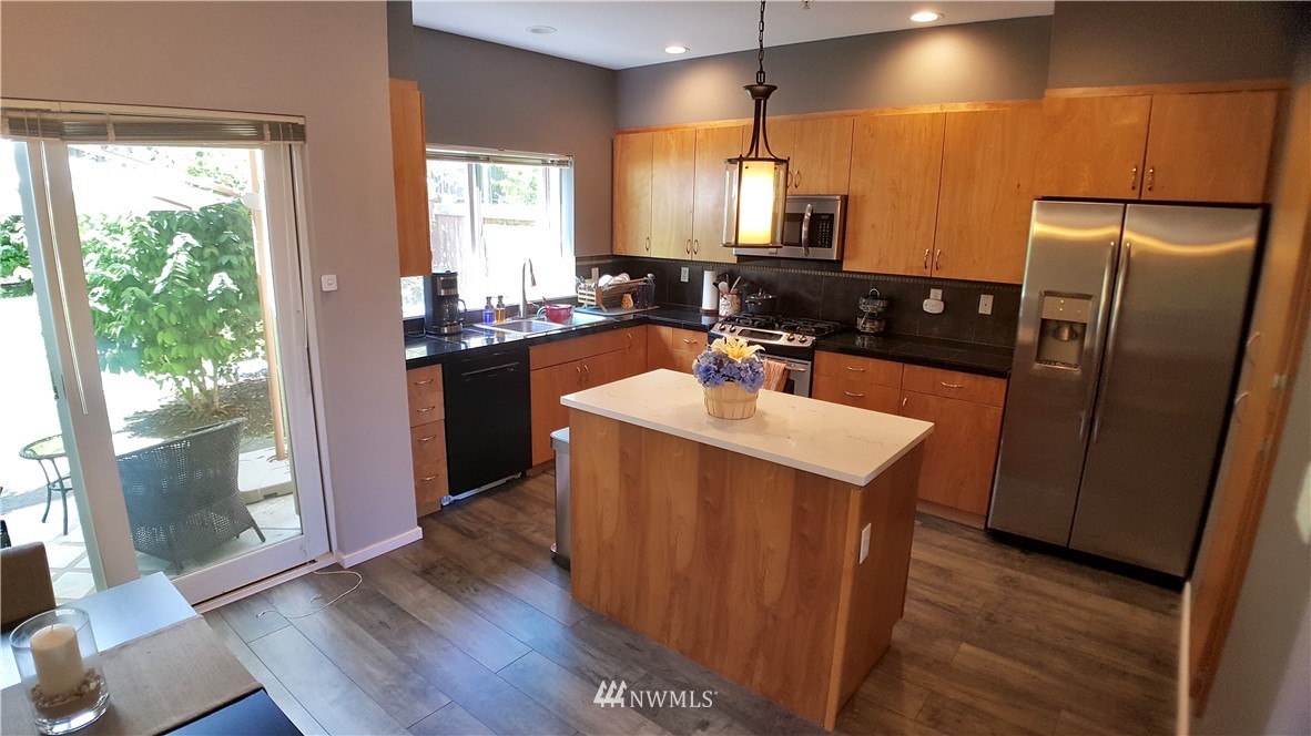 135 Cougar Ridge Road Northwest Issaquah, WA 98027 - Photo 7 of 22 a kitchen with a sink a counter top space and stainless steel appliances