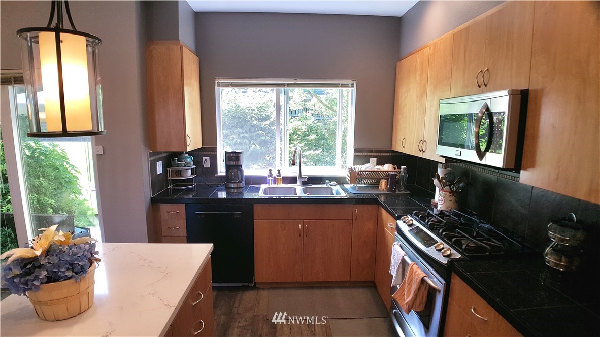 135 Cougar Ridge Road Northwest Issaquah, WA 98027 - Photo 8 of 22 a kitchen with a large window and cabinets