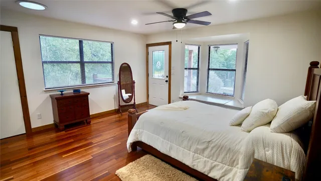 a bedroom with a bed window and a table