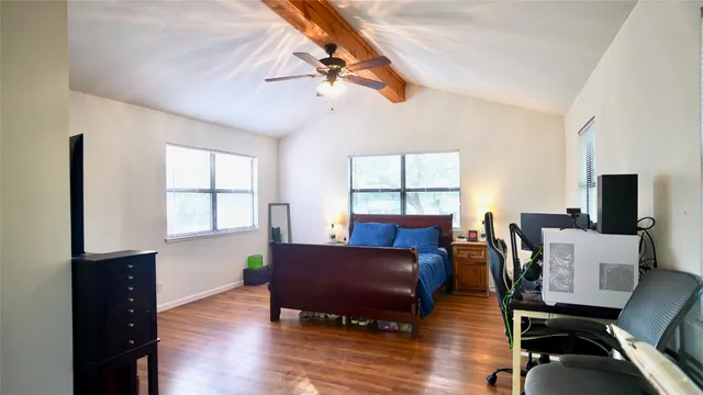 a living room with furniture a flat screen tv and a window