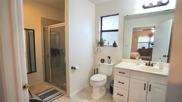 a bathroom with a sink toilet and shower