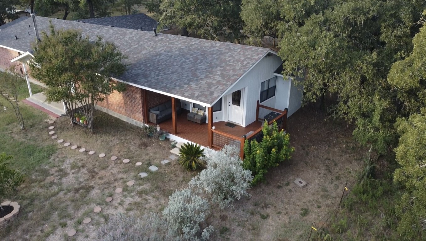 535 Paintbrush Trail Lockhart, TX 78644 - Photo 23 of 26 a aerial view of a house with yard and trees in the background