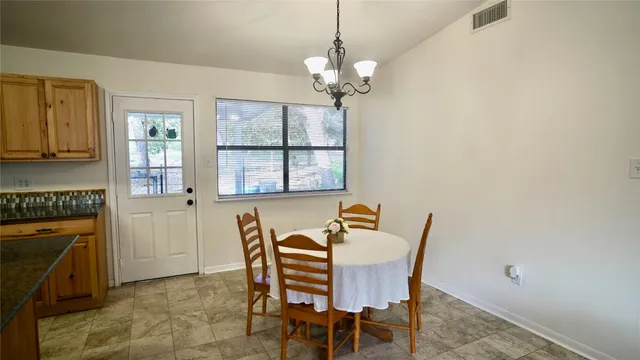 a dining room with furniture and window